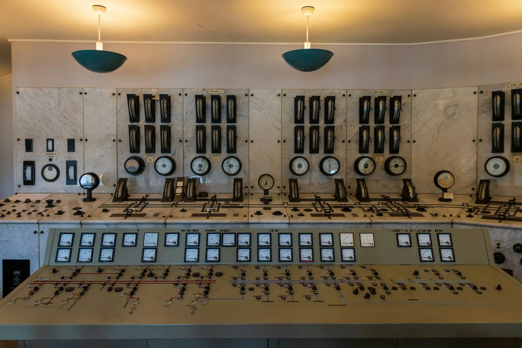 A large analogue control room with rows of gauges and switches