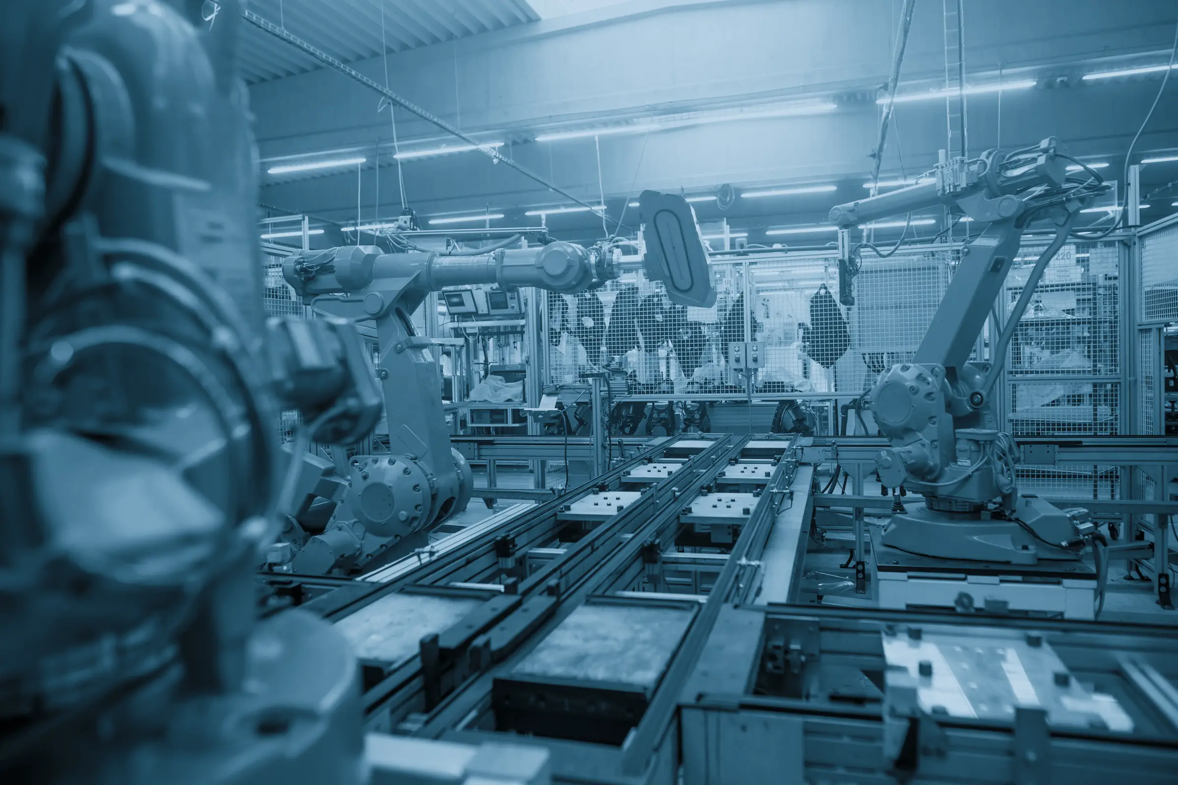 Industrial robot arms along a production line
