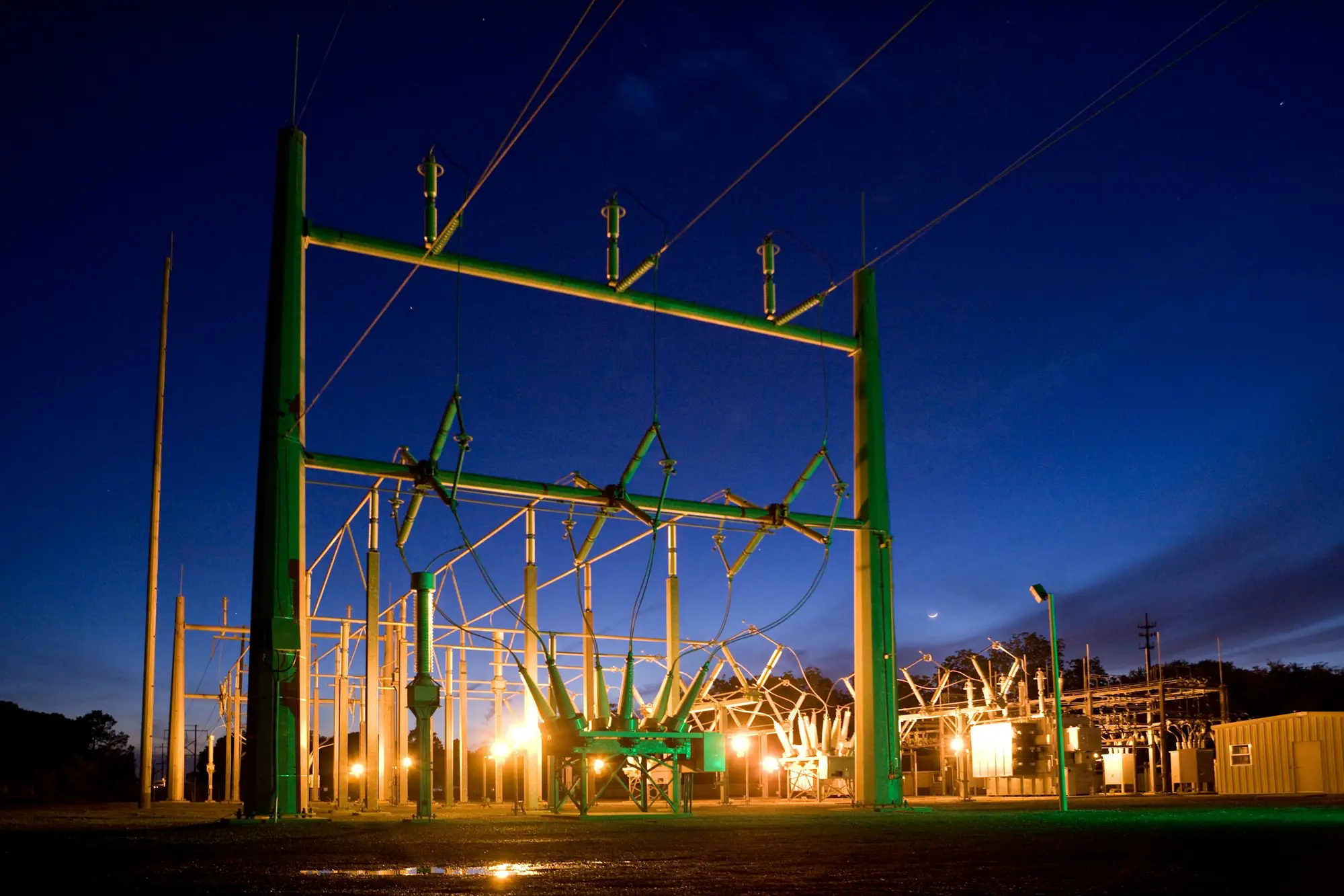 An electrical substation illuminated at night